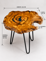 AI-styled view of Zitun Atelier table 002, an olive wood resin side table with teal resin knot, on a light background with measurement annotations.