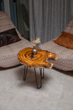 Styled overhead view of Zitun Atelier table 002, a live-edge olive wood side table with teal resin between two armchairs.