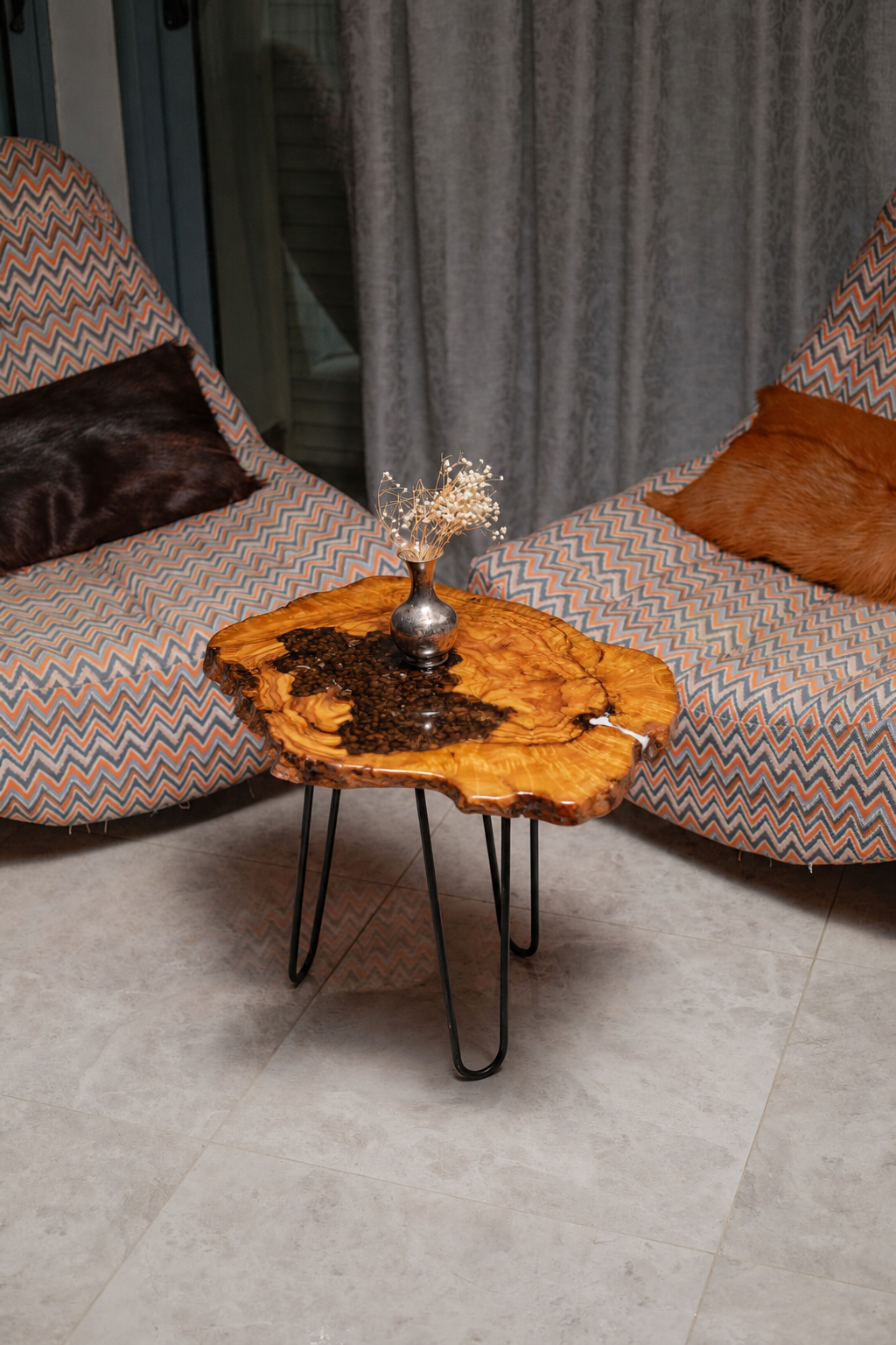 AI-styled view of Zitun Atelier table 004, an olive wood resin side table with coffee bean resin, viewed from above between two upholstered armchairs.