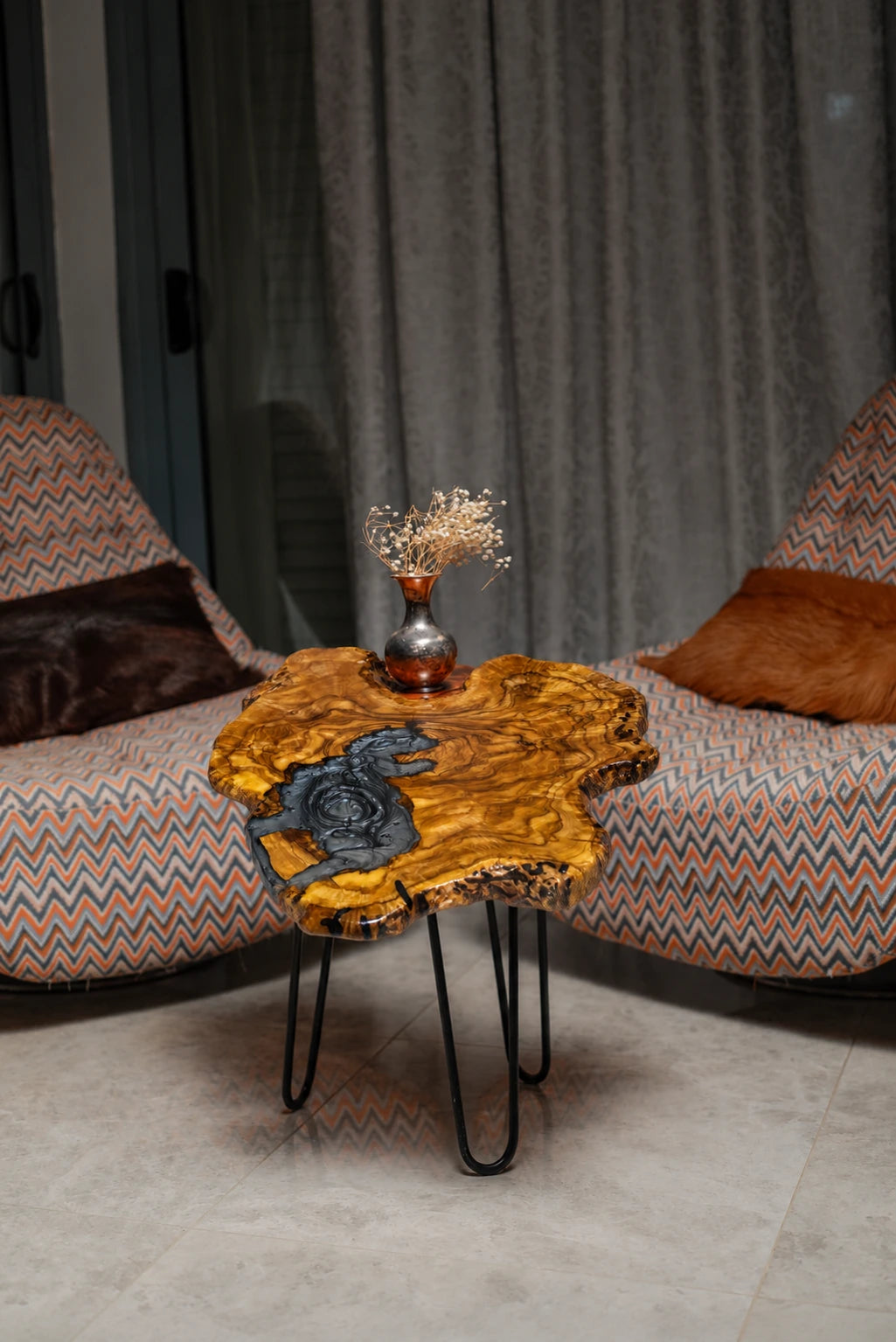 AI-styled view of Zitun Atelier table 039, an olive wood resin side table with grey swirl resin, in a lounge setting with a vase on the tabletop.