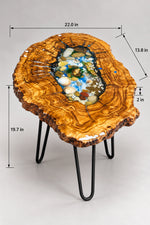 AI-styled view of Zitun Atelier table 052, an olive wood resin side table with sea shell pebble resin, on a light background with measurement annotations.