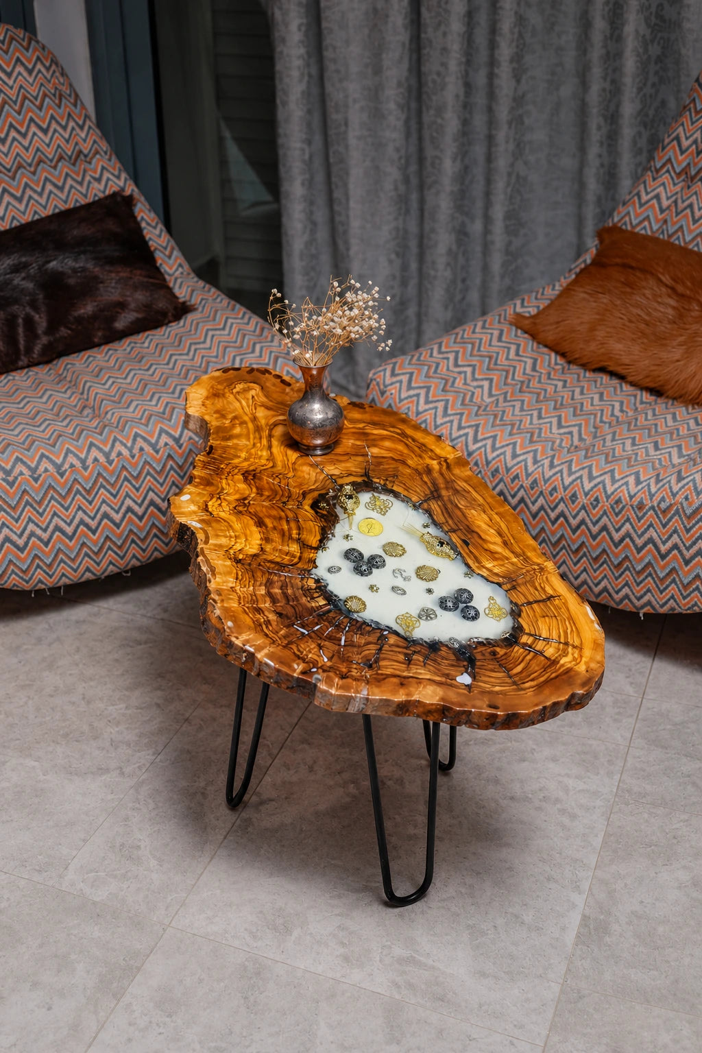 AI-styled view of Zitun Atelier table 063, an olive wood resin side table with white resin vintage coins, viewed from above between two upholstered armchairs.