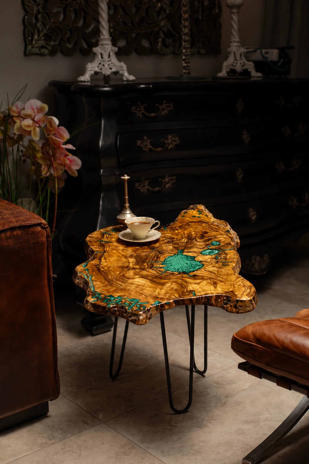 AI-styled view of Zitun Atelier table 067, an olive wood resin side table with turquoise green resin, in a dark interior beside leather seating.