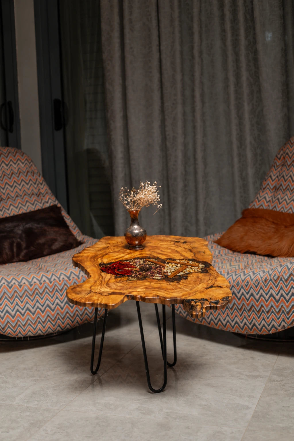 AI-styled view of Zitun Atelier table 082, an olive wood resin side table with red chili spice resin, in a lounge setting with a vase on the tabletop.