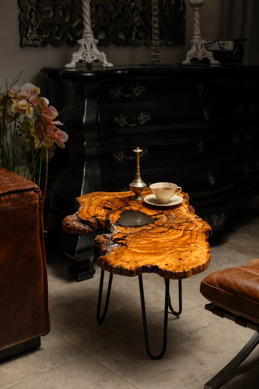 AI-styled view of Zitun Atelier table 085, an olive wood resin side table with white resin live edge, in a dark interior beside leather seating.