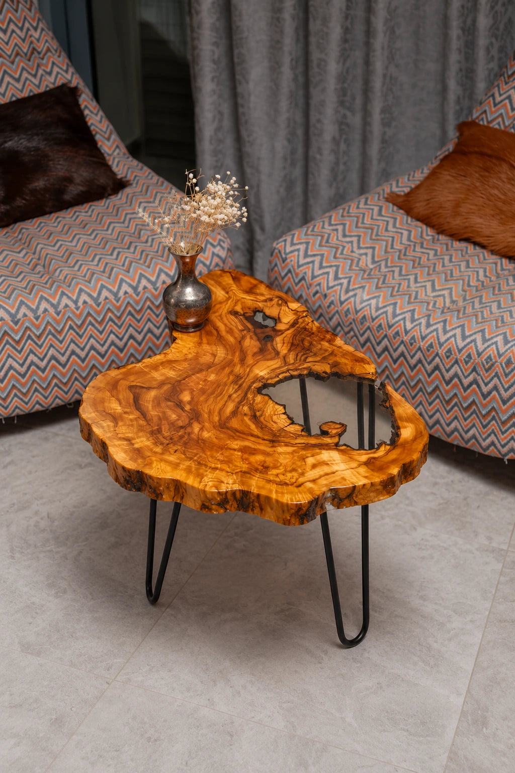 AI-styled view of Zitun Atelier table 086, an olive wood resin side table with white resin live edge, viewed from above between two upholstered armchairs.