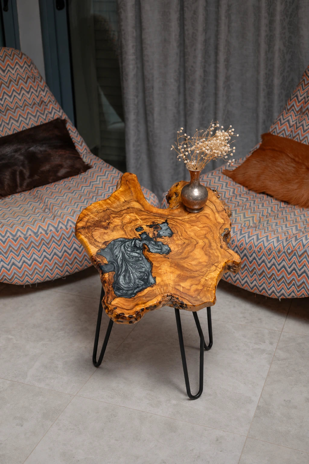 AI-styled view of Zitun Atelier table 091, an olive wood resin side table with black marble resin, viewed from above between two upholstered armchairs.