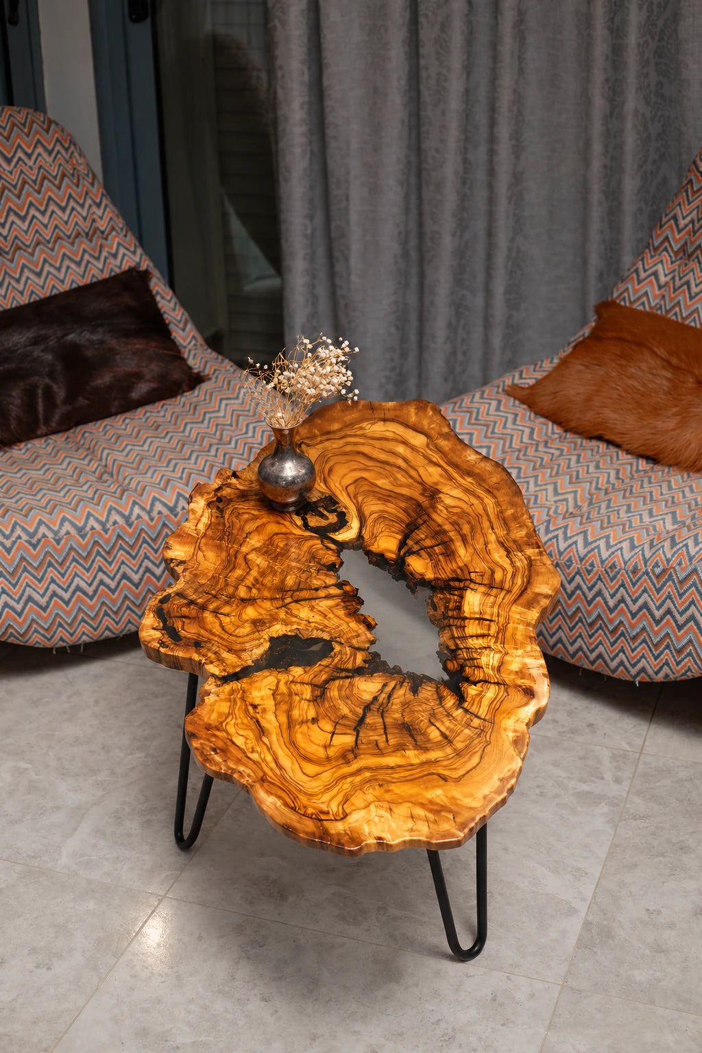 AI-styled view of Zitun Atelier table 096, an olive wood resin small coffee table with white resin river, viewed from above between two upholstered armchairs.